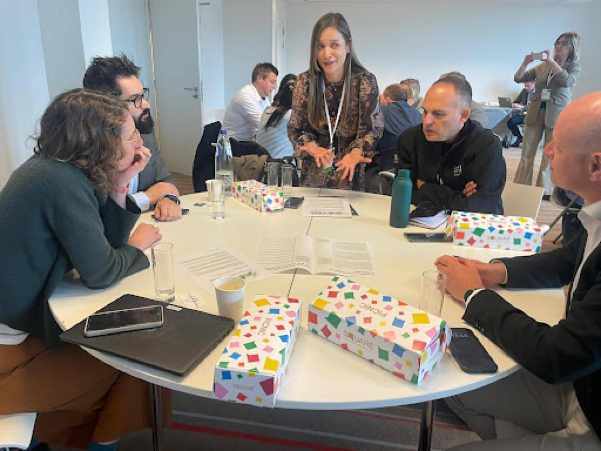 Drastic World Economic Forum workshop - group around a table discussing.