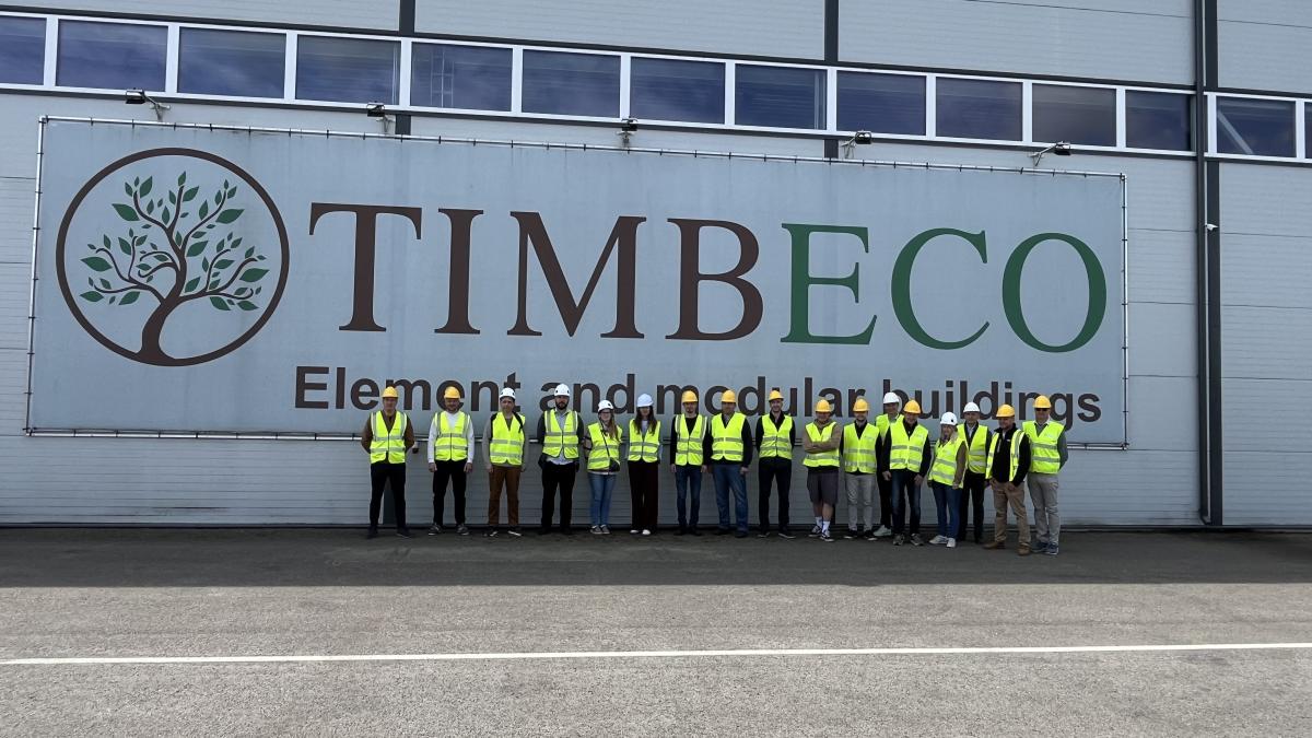 Ateendees stand outside Timbeco's premises. 